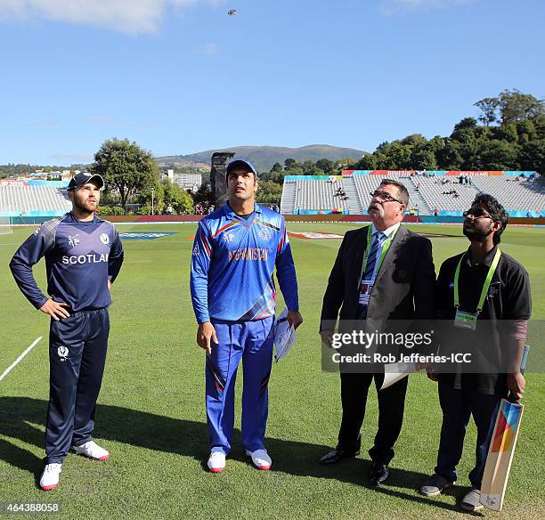 Preston Mommsen of Scotland and Mohammad Nabi of Afghanistan with David Boon at the coin toss during the 2015 ICC Cricket World Cup match between...