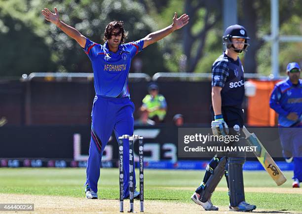 Afghanistan bowler Shapoor Zadran celebrates dismissing Scotland batsman Matthew Cross during their 2015 Cricket World Cup Group A match in Dunedin...