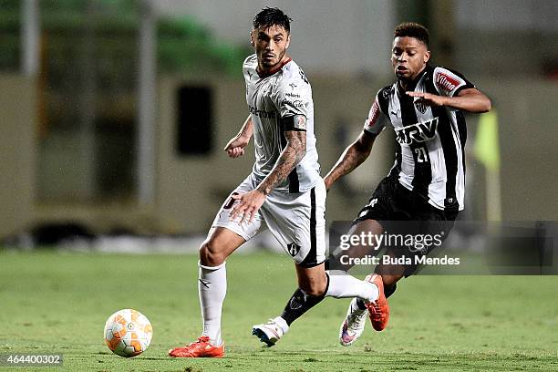 Andre of Atletico MG struggles for the ball with a Rodrigo Millar of Atlas during a match between Atletico MG and Atlas as part of Copa Bridgestone...