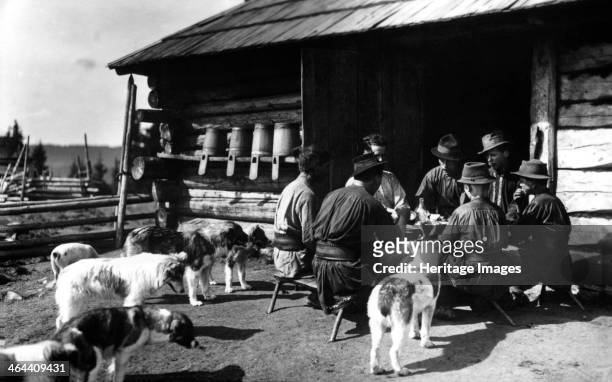 Shepherds taking a break for lunch, Bistrita Valley, Moldavia, north-east Romania, c1920-c1945. Depicting customs and traditional labour in the rural...
