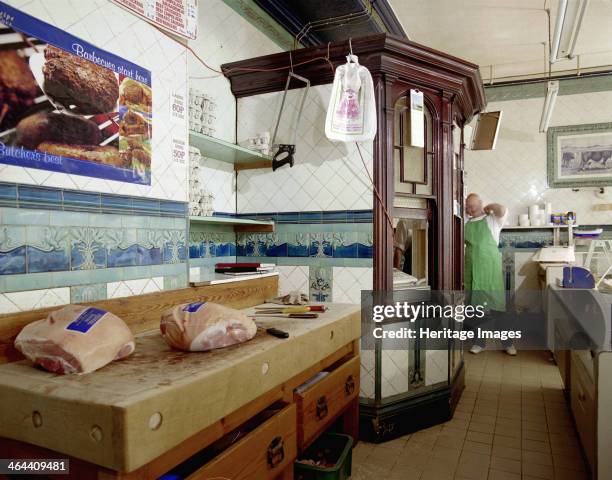 Chopping block and the cashier's box inside A Scarratt's butcher's shop at 47 High Street, Ilfracombe, Devon, 2000. Bacon joints wait on the block...