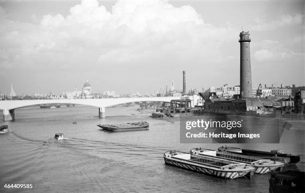 Waterloo Bridge, London, during its construction in 1937-42. The tower at the southern end of the bridge was a shot tower, built in 1811-17 and since...
