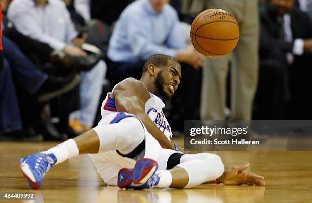 Chris Paul of the Los Angeles Clippers is tripped up on the court during their game against the Houston Rockets at the Toyota Center on February 25,...