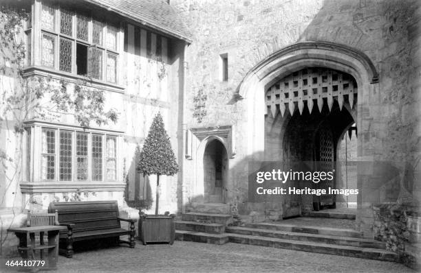 South-east corner of the courtyard at Hever Castle, Kent, c1900. The double portcullis of the entrance arch of the gatehouse, and the two-storey...