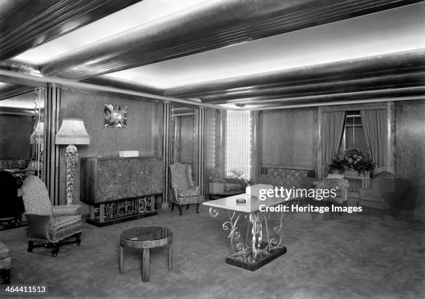 Reception room at the Odeon, Leicester Square, London, 1937. The strong horizontal lines of the ceiling, corner light feature, and mirrors with...