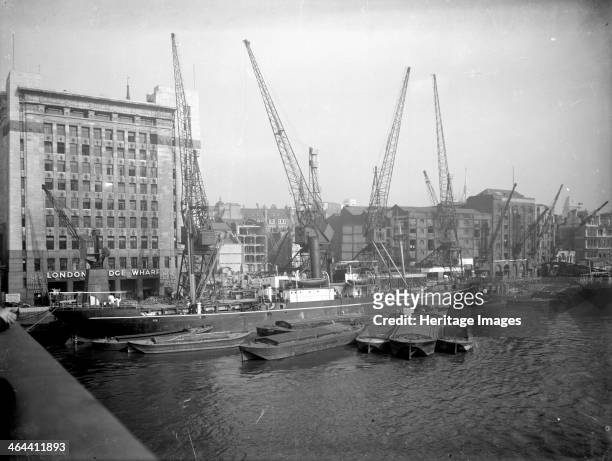 Cargo ship and Thames barges moored at London Bridge Wharf , London, seen from London Bridge. Adelaide House was built as a warehouse and offices in...