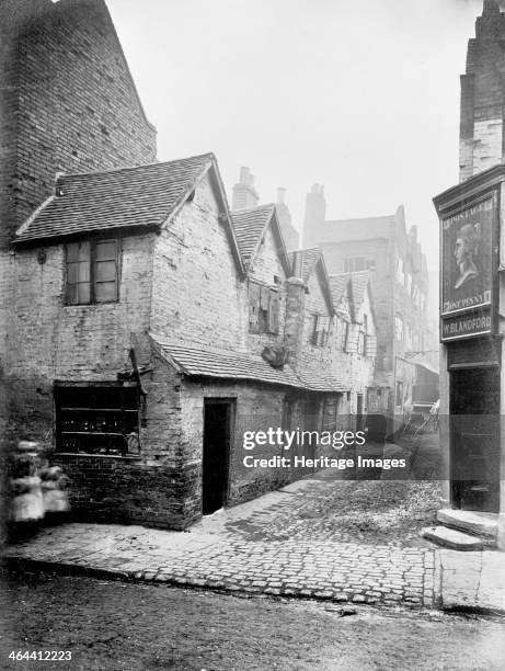 View into Queen's Head Yard in Birmingham, which is badly run-down. The photograph was possibly taken in the nineteenth century as there is a cart...