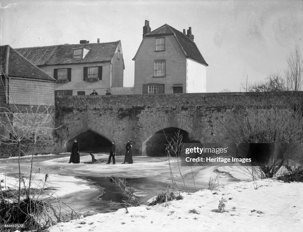 A group skating on the frozen River Thames, Abingdon Bridge, Abingdon, Oxfordshire, c1860-c1922. Artist: Henry Taunt