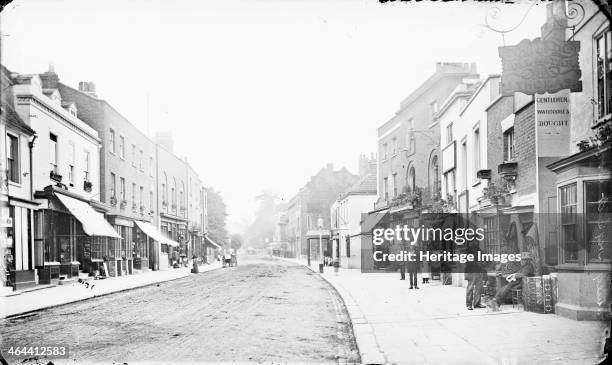 High Street, Putney, Greater London, c1860-c1922. Looking up the street, lined with shops, with the Bull and Star public house in the foreground.