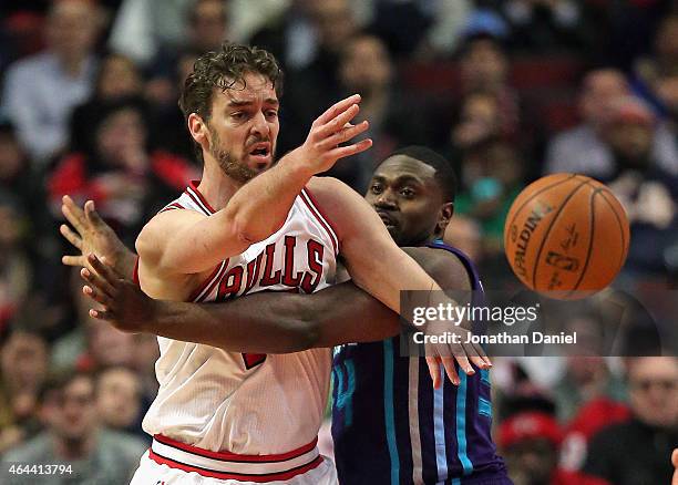 Pau Gasol of the Chicago Bulls passes under pressure from Jason Maxiell of the Charlotte Hornets at the United Center on February 25, 2015 in...