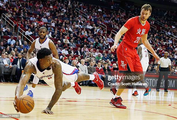 DeAndre Jordan of the Los Angeles Clippers dives for the basketball in front of Donatas Motiejunas of the Houston Rockets during their game at the...