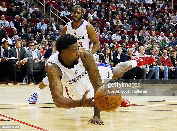 DeAndre Jordan of the Los Angeles Clippers dives for the basketball in front of teammate Chris Paul during their game against the Houston Rockets at...