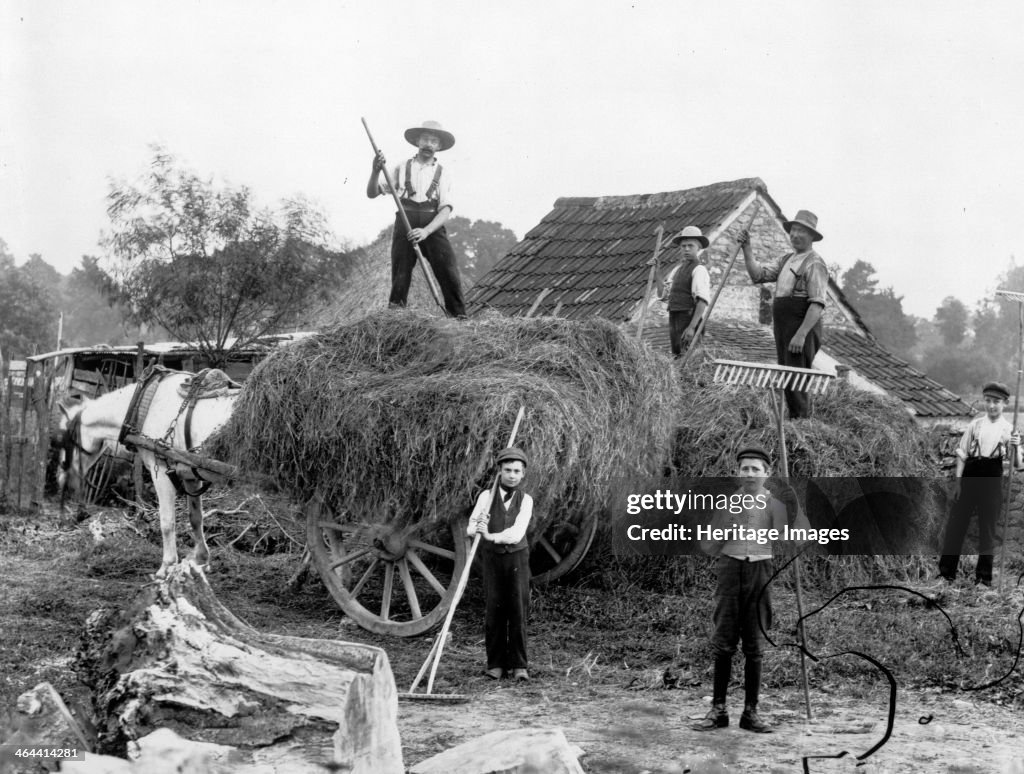 Men and boys with tools and a haycart, c1860-c1922. Artist: Henry Taunt