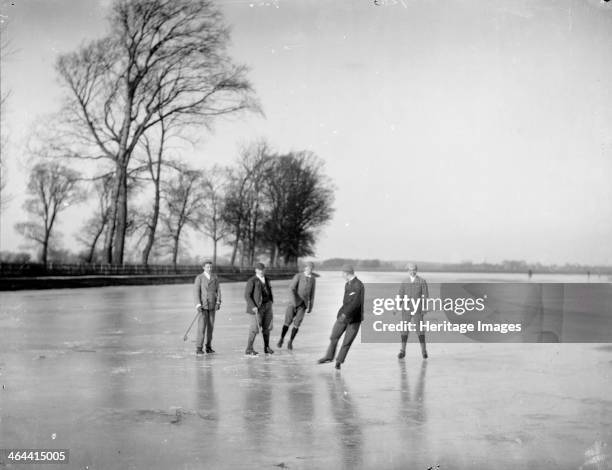 Local men playing a simple form of ice hockey on the frozen Medley Port Meadow, Oxford, Oxfordshire, c1860-c1922.