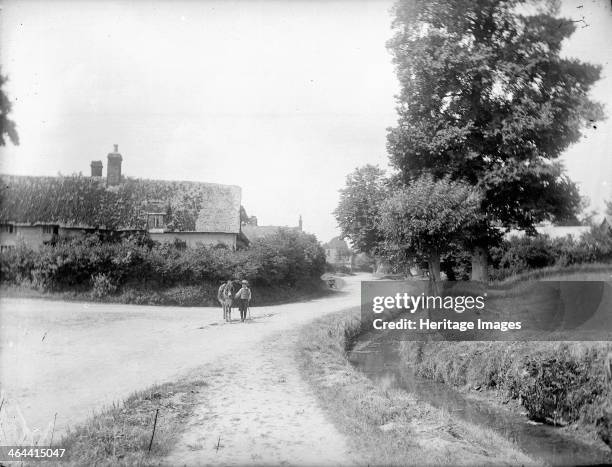Small boy and a donkey on a road leading into Chalgrove, Oxfordshire, c1860-c1922.