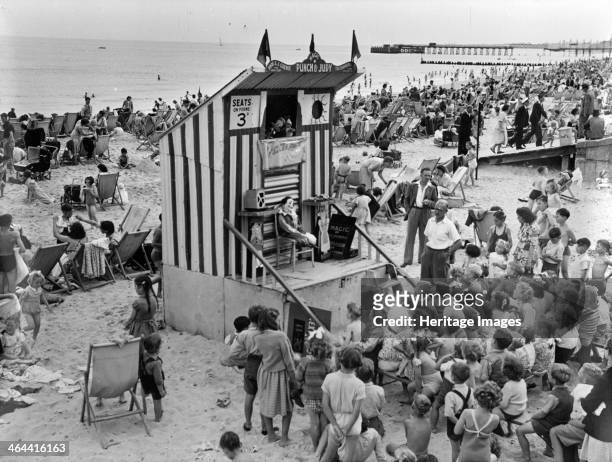 Punch and Judy show, Lowestoft, Suffolk, August 1949. Children watching a Punch and Judy show on the beach at Lowestoft at a charge of 3d. Lowestoft...