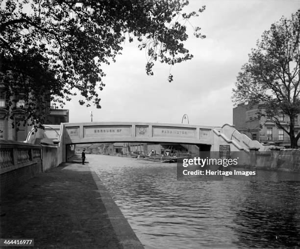 Footbridge over the Grand Union Canal at Formosa Street, Paddington, London, soon after construction in 1914. Barges are moored beyond the bridge and...