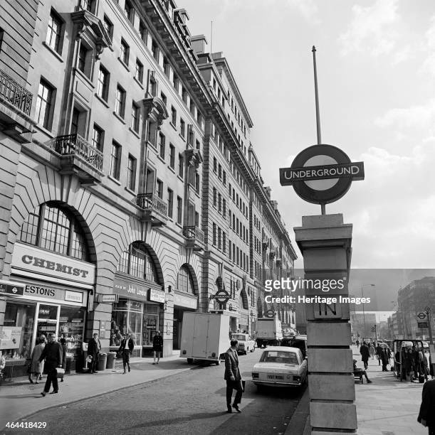 Baker Street underground station, London, 1960-1972. The Underground sign in front of the shops and station entrance on the Marylebone Road elevation...
