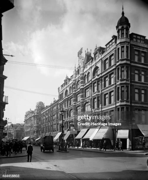 Hotel Cranbourn, Shafesbury Avenue , Westminster, London, 1921. Shops on the street frontage have their sun blinds pulled out over the pavement while...