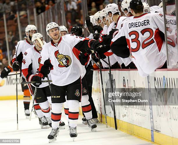 Erik Condra of the Ottawa Senators celebrates with teammates as he skates by the bench after scoring a goal in the first period against the Anaheim...