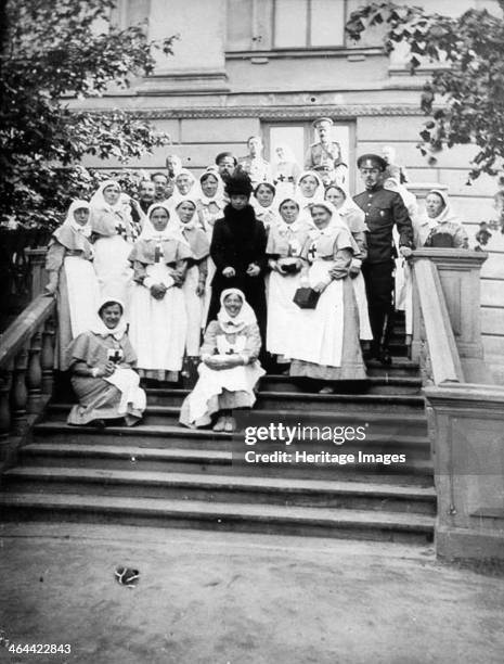 Dowager Empress Maria Feodorovna of Russia with nurses outside a hospital, Russia, 1916. Born Princess Dagmar of Denmark, Maria Feodorovna married...