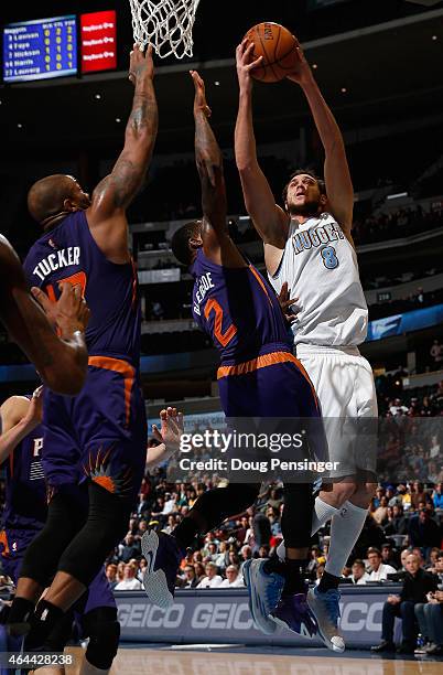 Danilo Gallinari of the Denver Nuggets puts up a shot against Eric Bledsoe of the Phoenix Suns at Pepsi Center on February 25, 2015 in Denver,...