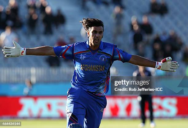 Shapoor Zadran of Afghanistan celebrates hitting the winning runs in Afghanistan's win over Scotland during the 2015 ICC Cricket World Cup match...