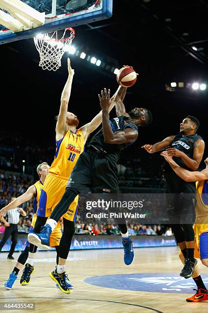 Ekene Ibekwe of the Breakers contests the rebound with Luke Schenscher of Adelaide during game one of the NBL Finals series between the New Zealand...