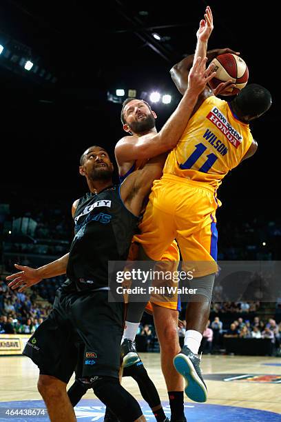 Mika Vukona of the Breakers contests the ball with Jamar Wilson and Anthony Petrie of Adelaide during game one of the NBL Finals series between the...