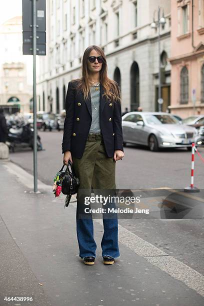 Carlotta Oddi wears a Palm Angels jacket, Isabel Marant t-shirt and skirt, Hudson jeans, Prada shoes, and Saint Laurent bag, and Spektre sunglasses...