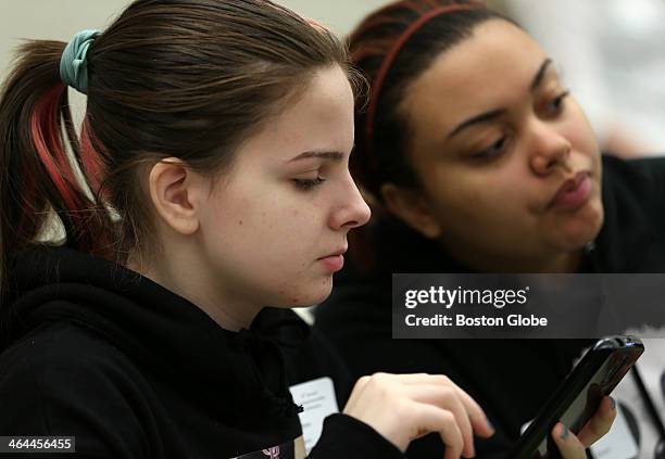 Lisa Reyes, left, from Lawrence High School, prepares to vote on her smart phone at the NFTE Youth Entrepreneurship Conference at Babson College, in...