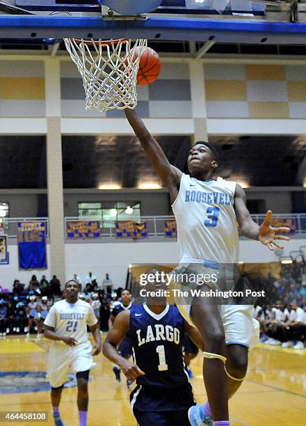 Roosevelt's Naji Marshall sails to the basket in front of Largo's Isaiah Boggs in the Prince Georges County championship game at Dr. Henry Wise High...