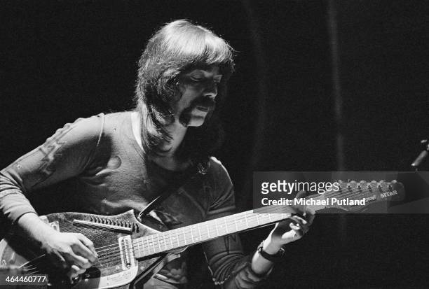 Guitarist Steve Hackett playing a a Coral electric sitar during a performance with English progressive rock group Genesis at the Theatre Royal, Drury...