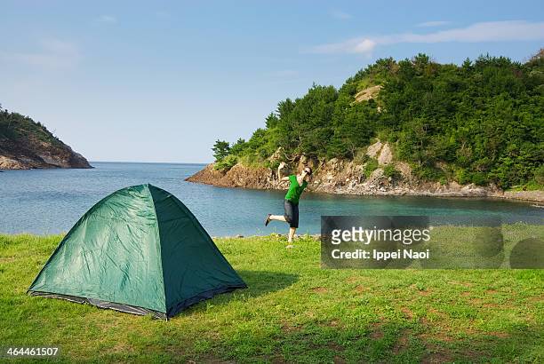woman enjoying camping by the sea - okinoshima stock pictures, royalty-free photos & images