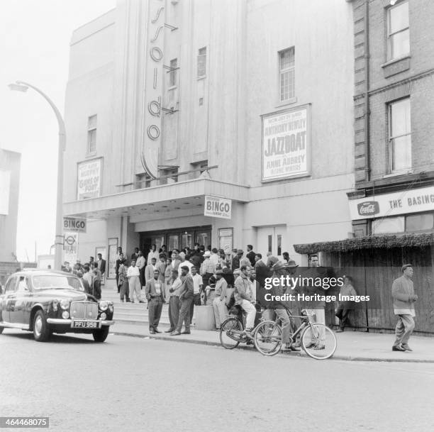 London street scene, 1961. A crowd of people standing outside the Essoldo.