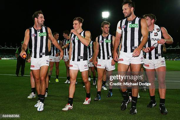 Steele Sidebottom of the Magpies Josh Kennedy and Nathan Brown walk off after their win during the NAB Challenge AFL match between Hawthorn Hawks and...