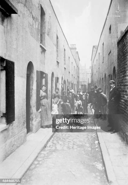 Little Collingwood Street, Bethnal Green, London, 1900s. Residents of the street pose for the photographer. Two of the boys in the front of the...