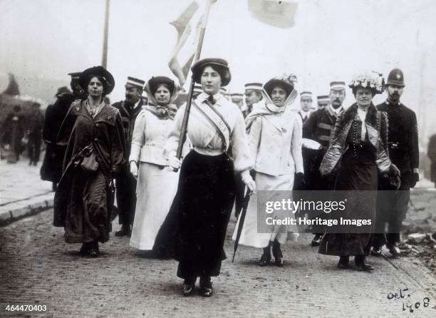 Daisy Dugdale leading a procession, London, 1908. Wearing the suffragette uniform in the colours of purple, green and white, Daisy Dugdale leads a...