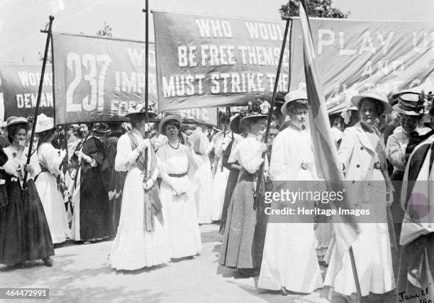 Suffragettes on the Euston Road procession carrying banners to Women's Sunday, London, 21st June 1908. The marching women were accompanied by drums...