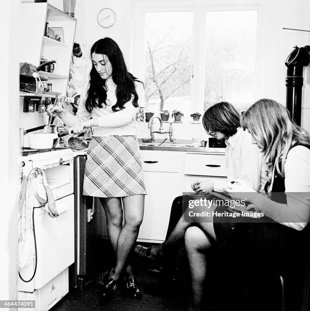 Three young people in the kitchen of a London flat, c1960s.