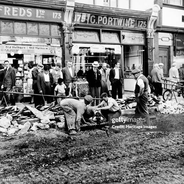 Road repairs in Portobello Road, London, c1956.