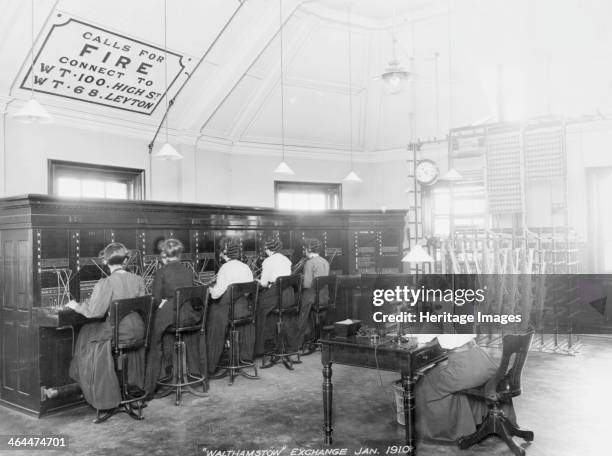 Walthamstow Telephone exchange, London, 1910. Female telephonists at the switchboard. On the wall are instructions concerning calls for the fire...