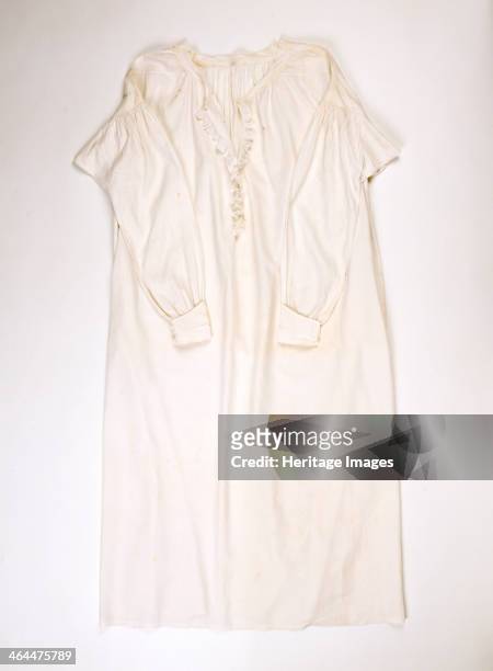 Fine Linen or cotton nightdress worn by Queen Victoria, c1838-c1901. Trimmed with lace and embroidered with the queen's cipher centre front.