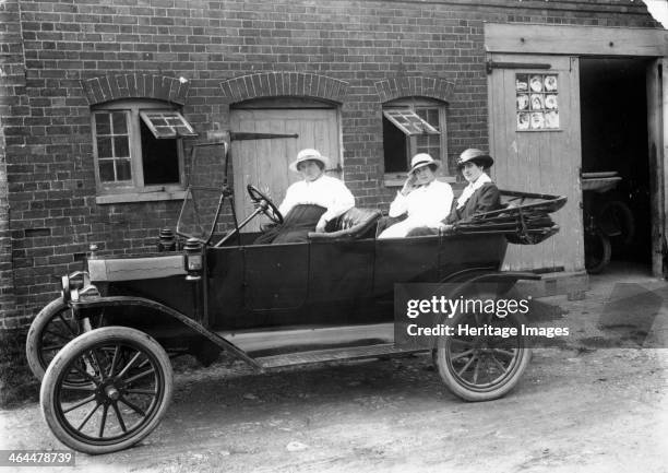 Model T Ford, c1913. Three women sitting in a Model T Ford, parked in front of a building. Henry Ford introduced the Model T in 1909 and the...