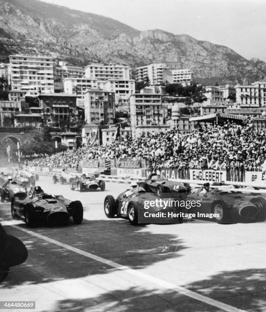 Cars on the starting grid, Monaco, 1950s. A large crowd prepare to watch the start. The buildings of Monte Carlo and the hillsides above provide a...