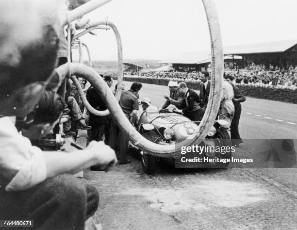 Delahaye 175S in the pits, Le Mans, France, 1951. An animated discussion is taking place between the driver and his pit crew during the Le Mans 24...