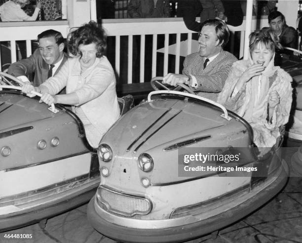 Graham Hill and Jim Clark on Dodgem cars at Butlins, Bognor Regis, 1960s. Mrs Campbell-Jones is on the Dodgem with Hill and Mrs Gregor Grant is in...