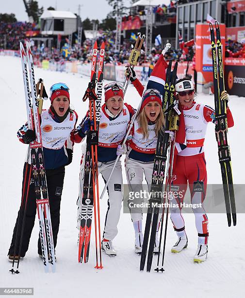 Heidi Weng, Therese Johaug, Astrid Uhrenholdt Jacobsen and Marit Bjoergen of Norway celebrate winning the gold medal in the Women's 4 x 5km...