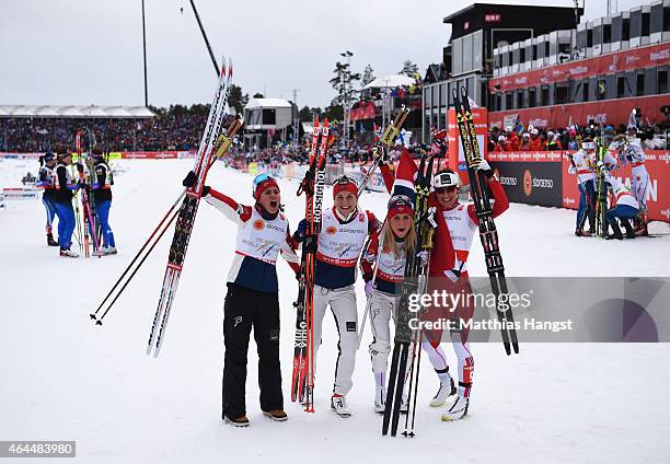 Heidi Weng, Therese Johaug, Astrid Uhrenholdt Jacobsen and Marit Bjoergen of Norway celebrate winning the gold medal in the Women's 4 x 5km...