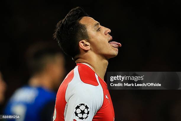 Alexis Sanchez of Arsenal pokes his tongue out during the UEFA Champions League round of 16, first leg match between Arsenal and Monaco at The...